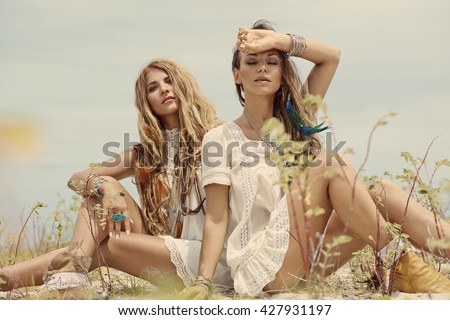 Two beautiful boho girls outdoors