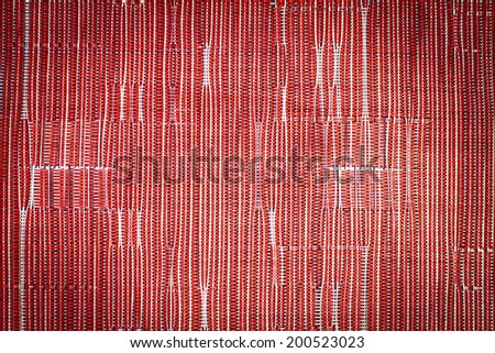 Red synthetic fabric pattern with vignette background