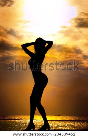 woman  good shape as silhouette with sunset