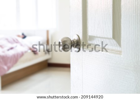 half opened bedroom door which have someone sleeping