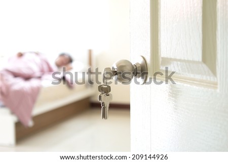 half opened bedroom  with key door which have someone sleeping