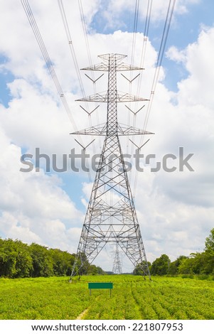 Electric transmission line tower with cloudy sky