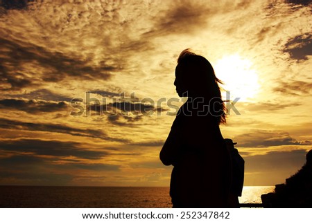 silhouette of woman standing to thinking of some things with hope
