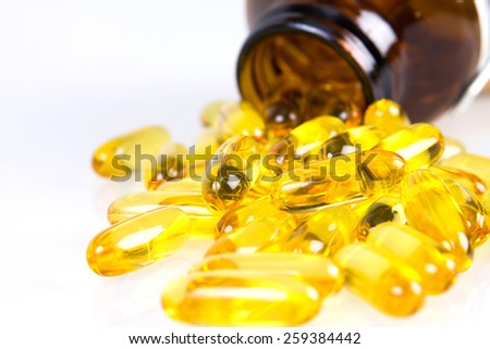 Closeup the yellow soft gelatin supplement omega 3 , fish oil capsule