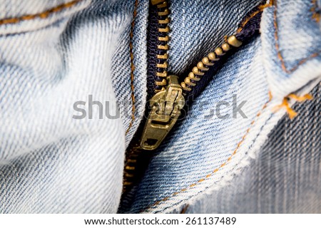 closeup metal zipper of the jeans pants , selective focus
