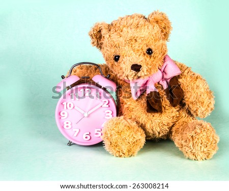 retro and vintage style of the Old fashioned alarm clock and cute brown bear doll