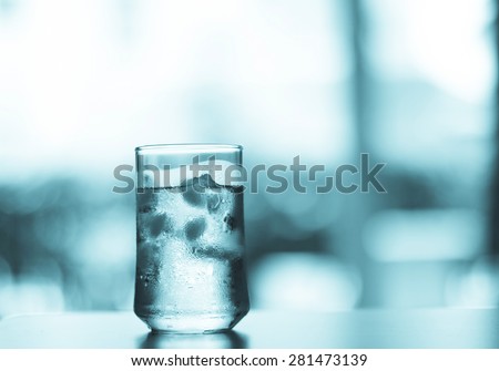 Cool blue color tone The glass of Cool fresh drink with ice cube on the  table  in living room
