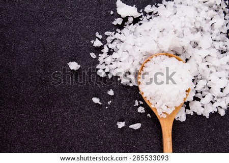 the salt crystals on black stone plate background