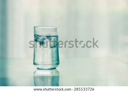 The glass of Cool fresh drink with ice cube on the  table