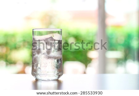 The glass of Cool fresh drink with ice cube on the  table