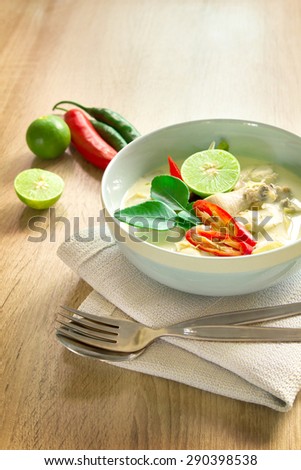 Spicy creamy coconut soup with chicken , Thai food called Tom Kha Gai on wooden table