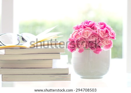 soft and selective focus of the fresh pink carnation flower with stacking of books background