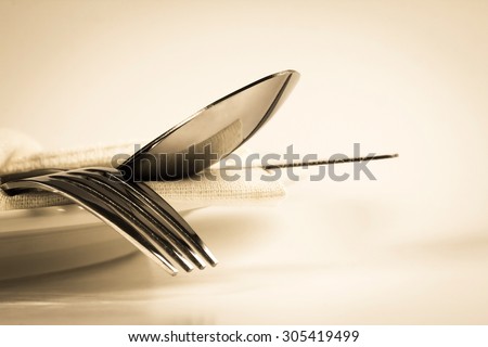 vintage color of close up dinning the silverware fork , spoon and knife with dish on white background and text space