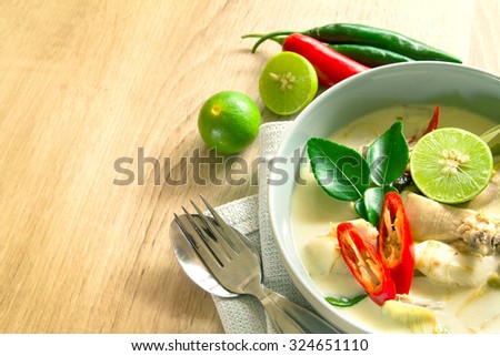Spicy creamy coconut soup with chicken , Thai food called Tom Kha Gai on wooden table