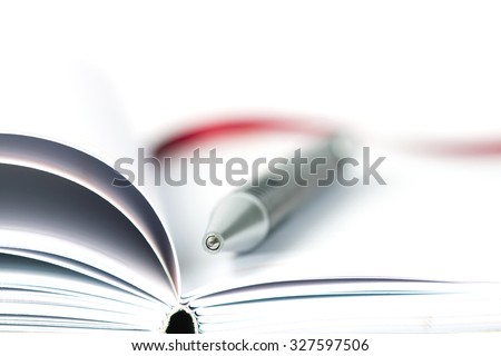 selective focus of the ball pen on opened lined diary book , extremely shallow DOF