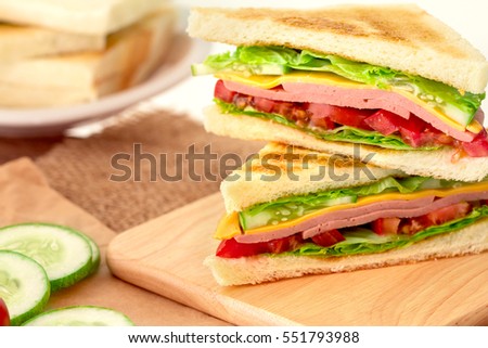 Sliced Grilled sandwiches bread with bacon , ham and cheese with vegetable , healthy breakfast