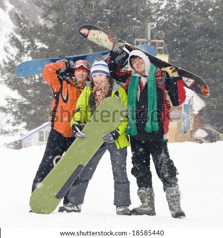 Happy snowboarding team in winter mountains, health lifestyle (series Sport, Extreme, Mountains, Horses and Teenagers)