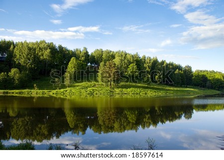 Blue reflection in river  at summer forest, Russia