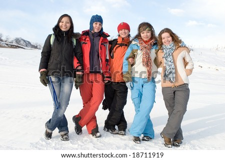 Group of sport teens different ethnicity winter outdoors at mountain Tien Shan. One boy and four girls