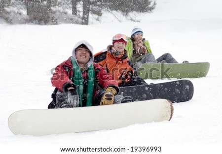 Group of sports teenagers snowborders in mountains in snow