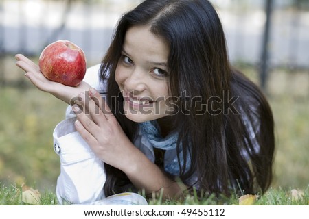 Woman with apple at the summer park