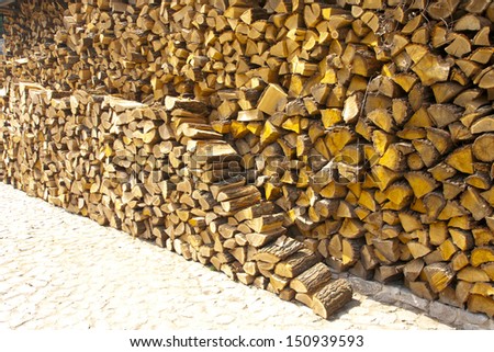 Warehouse of fire wood combined under a wall accurately
