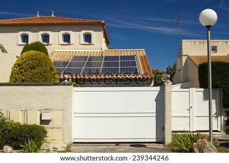Solar panels on the roof of a private home. Roof tiles. Blue sky sunny summer day