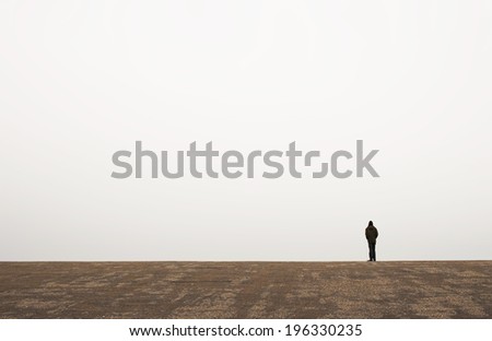 man waiting alone on the horizon line