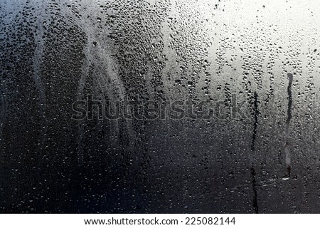 after the storm, water drops and condensation in a window glass