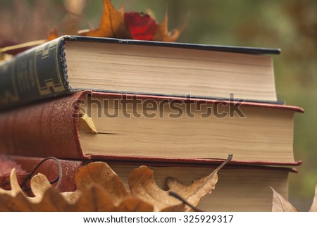 old books and fallen autumn leaves