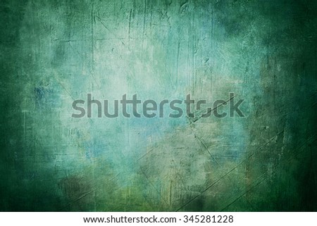 blue grunge background or texture with dark vignette borders and spotlight