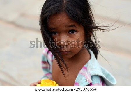 SIEM REAP, CAMBODIA - APRIL 12: Portrait of an unidentified Khmer girl on Angkor Wat Temple, Siem Reap, Cambodia on 12.2015 April .