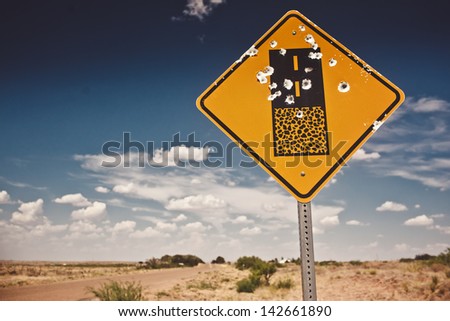Road sign full of shotgun holes found at New Mexico, USA