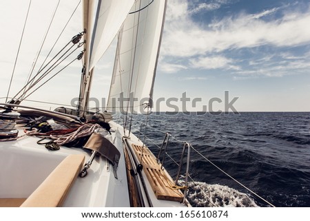 Sailing ship yachts with white sails in the open sea