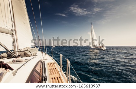 Sailing ship yachts with white sails in the open sea Sailing ship yachts with white sails in the open sea