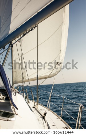 Sailing ship yachts with white sails in the open sea