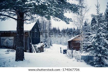 Wooden cottage in winter forest covered by snow in Central Finland