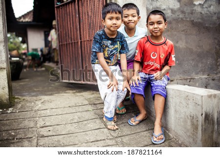 BALI, INDONESIA - JANUARY 16, 2013: Three Balinese boys on January 16, 2013 in Bali, Indonesia