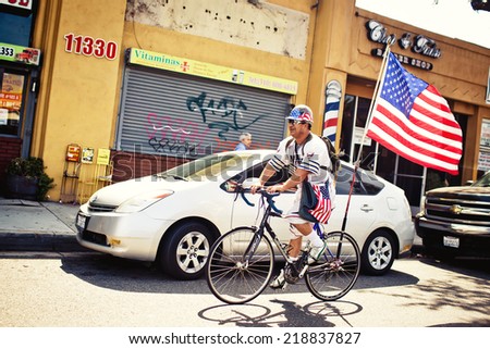 SAN BERNANDINO, USA - AUGUST 7, 2011: Man riding bike on August 7, 2011, San Bernandino, CA, USA