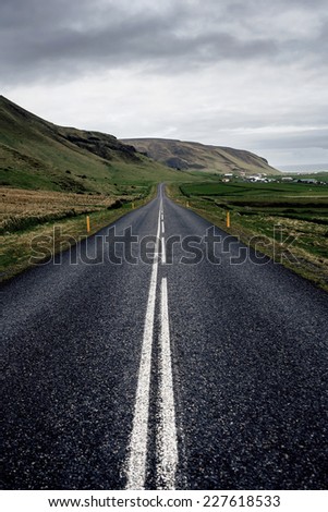 Winding mountain road next to Hvalfjordur fiord in Iceland