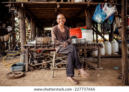 KAMPONG PHLUK,CAMBODIA - JANUARY 01: Portrait of an unidentified Khmer man on Tonle Sap Lake in Kampong Phluk,Cambodia on 01.2014 January .It is the largest lake in Southeast Asia
