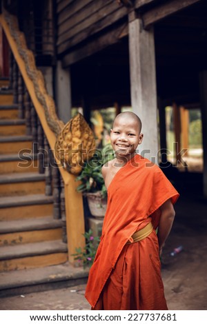 ANGKOR WAT,CAMBODIA - DECEMBER 31: An unidentified monk poses for a photo in Angkor Wat complex on Cambodia on December 31,2013. Angkor Wat was first a Hindu, then a Buddhist temple complex.