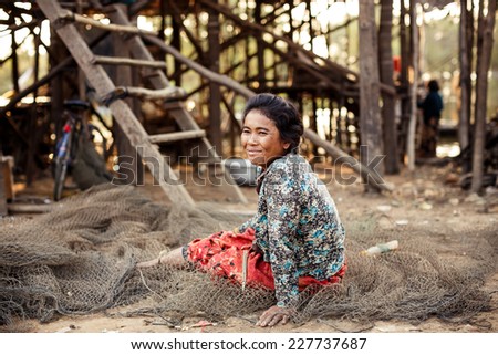 KAMPONG PHLUK,CAMBODIA - JANUARY 01: Portrait of an unidentified Khmer woman on Tonle Sap Lake in Kampong Phluk,Cambodia on 01.2014 January .It is the largest lake in Southeast Asia.