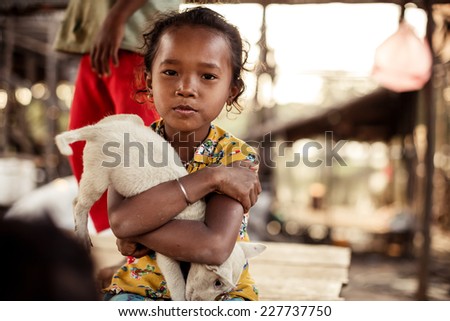 KAMPONG PHLUK,CAMBODIA - JANUARY 01: Portrait of an unidentified Khmer girl on Tonle Sap Lake in Kampong Phluk,Cambodia on 01.2014 January .It is the largest lake in Southeast Asia