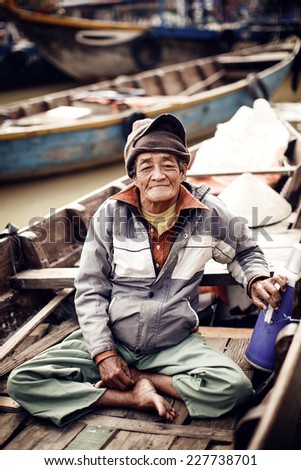 HUE,VIETNAM - DECEMBER 28: Old man on a boat in river on December 28, 2013,Vietnam.