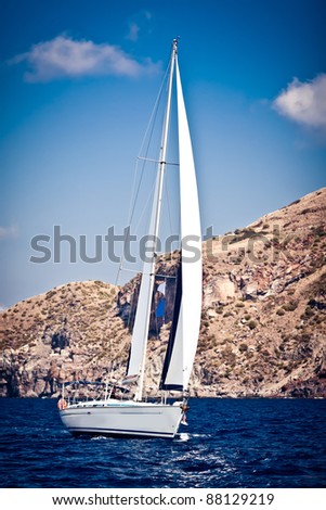 Sailing ship yacht with white sail in open sea