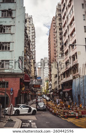 HONG KONG, CHINA - MAY 22, 2014: Typical Hong Kong street with urban buildings, road and traffic on May 22, 2014