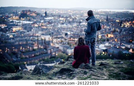 EDINBURGH, SCOTLAND - MAY 06, 2014: Couple on hill in Edinburgh. Edinburgh is the capital city and second most populous city in Scotland.