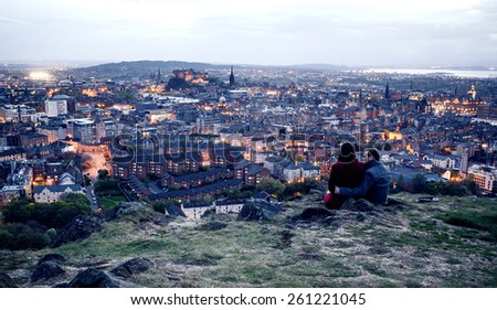 EDINBURGH, SCOTLAND - MAY 06, 2014: Couple on hill in Edinburgh. Edinburgh is the capital city and second most populous city in Scotland.