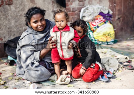 DELHI, INDIA - JANUARY 5, 2015: Poor Indian family of mother and two daughters on January 5, 2015 in Delhi, India